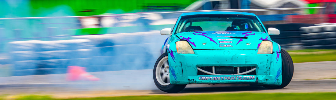 Turquoise 350Z drift car sliding through smoke for Driftaholic Racing sim drifting article
