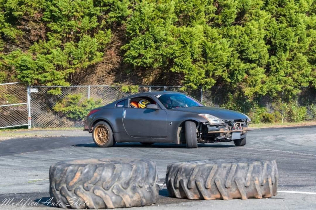 Gray Nissan 350Z drifting at maximum angle on the Piedmont Drift Boss Circuit